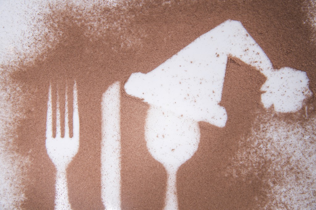 Representation of the Christmas holiday with cutlery on the plate and a dusting of cocoa
