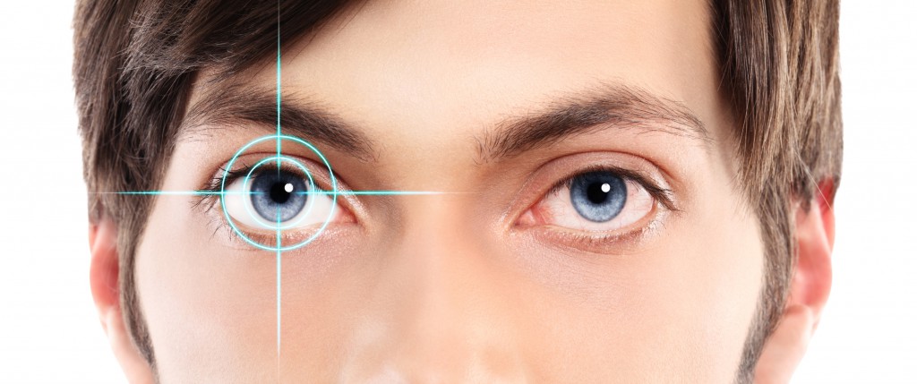 Closeup of blue eyes from a young man red and irritated eye with laser hologram on her eye